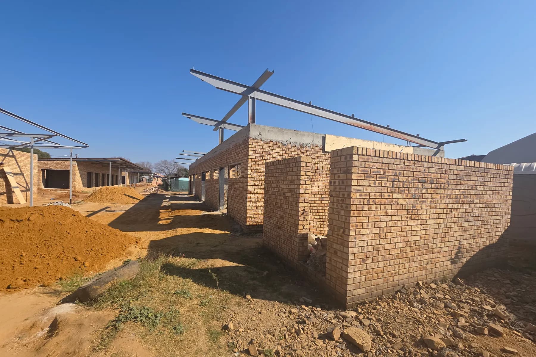 Steel roof framing over new brickwork