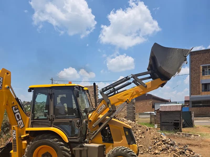 Backhoe working inside a taped-off site