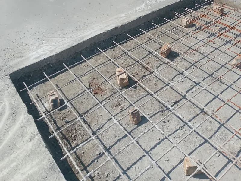 Mesh on brick spacers beside a finished slab