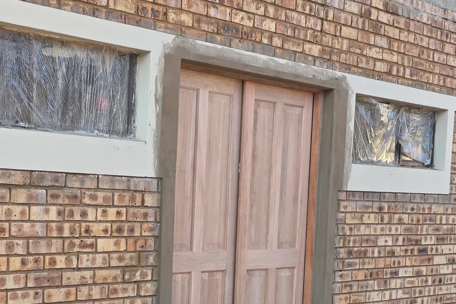Timber doors hung in a finished face brick building